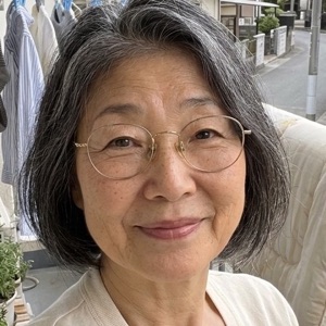 Emiko with a cup of coffee on her balcony